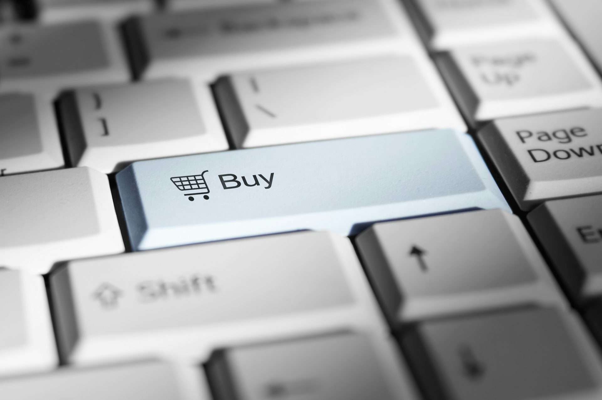 Close-up of a keyboard with a highlighted Buy button symbolizing online shopping.